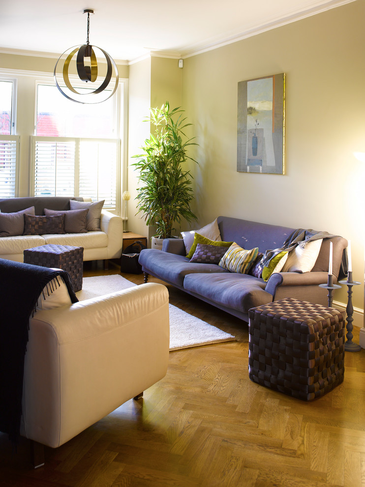 Example of a large transitional living room design in London with beige walls