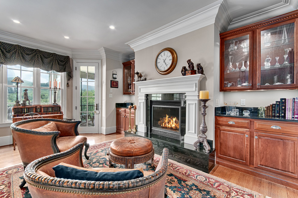 This is an example of a traditional living room in Other with grey walls, medium hardwood flooring and a standard fireplace.