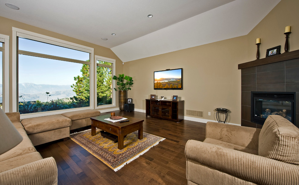 Photo of a large traditional open plan living room in Vancouver with beige walls, dark hardwood flooring, a corner fireplace, a tiled fireplace surround and a wall mounted tv.