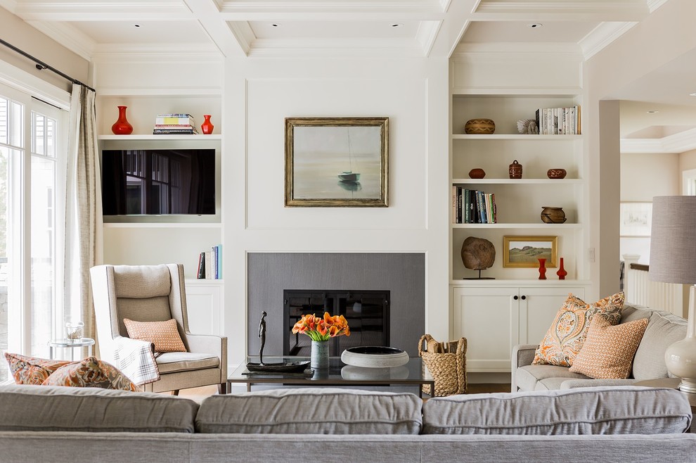 This is an example of a large classic formal living room in Boston with white walls, a standard fireplace and a wall mounted tv.