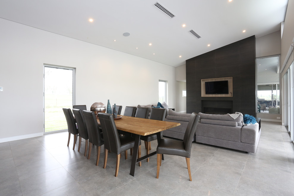 This is an example of an expansive modern formal open plan living room in Sydney with beige walls, porcelain flooring, a standard fireplace, a tiled fireplace surround and grey floors.