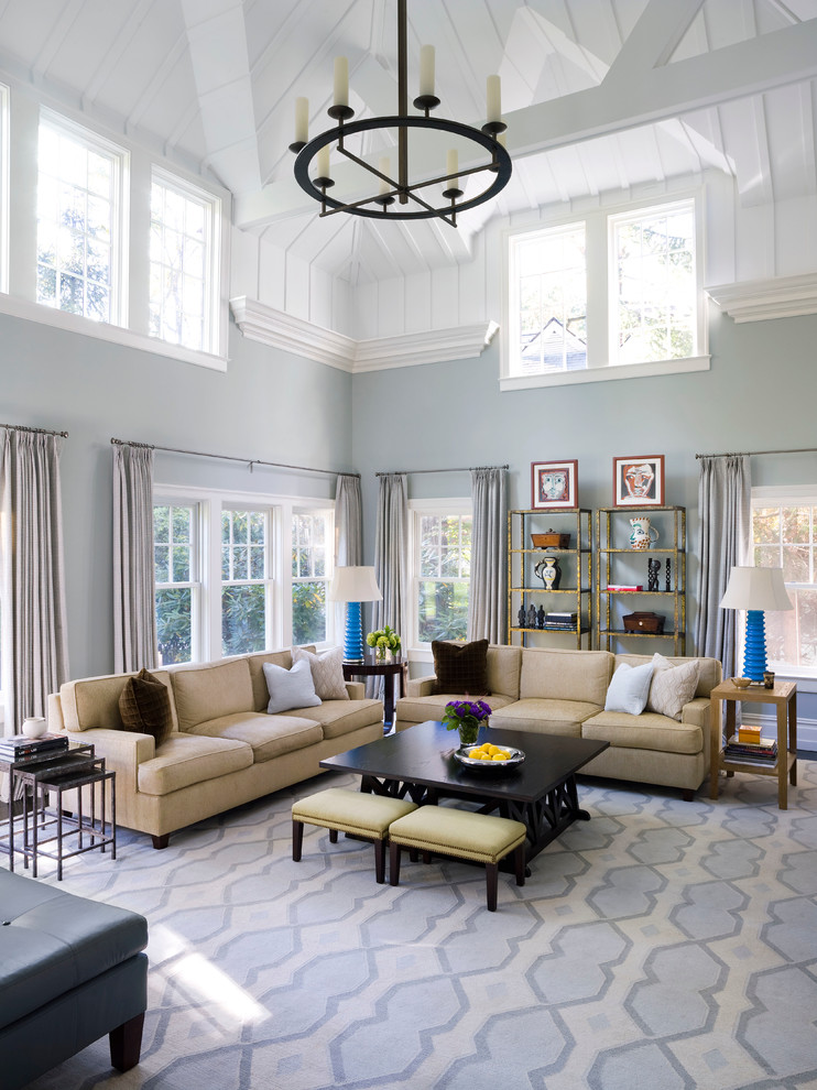 Photo of a classic open plan living room in New York with blue walls and feature lighting.