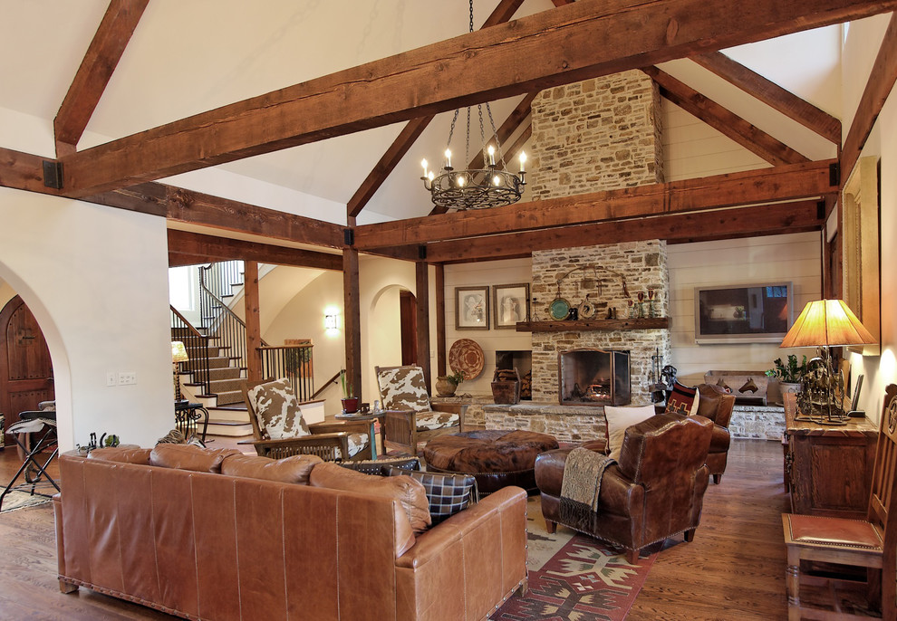 Example of a southwest living room design in Atlanta with a stone fireplace