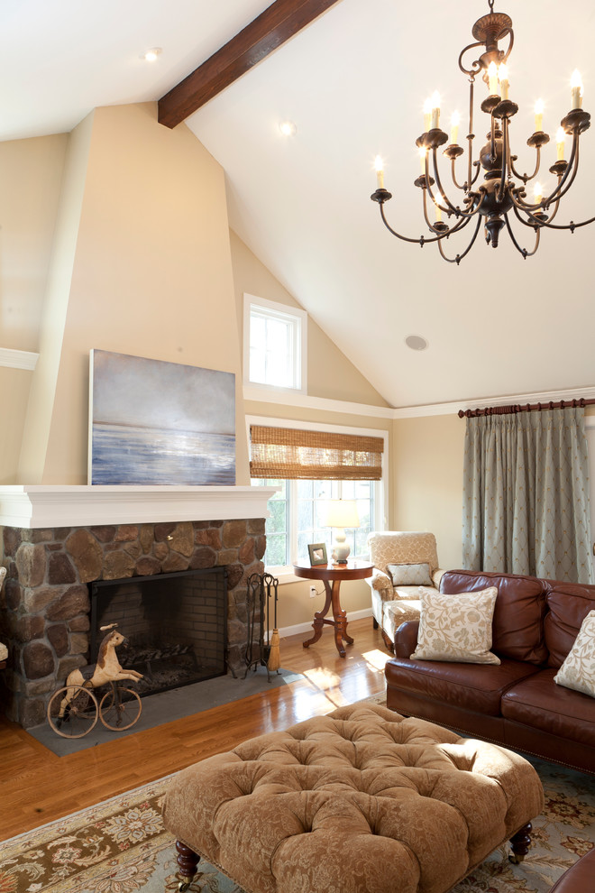 Large classic open plan living room in Salt Lake City with beige walls, medium hardwood flooring, a standard fireplace, a stone fireplace surround, brown floors and a wall mounted tv.