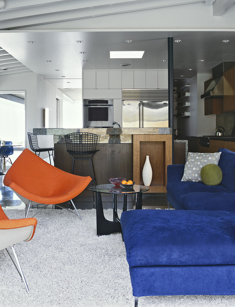 Example of a large mid-century modern open concept concrete floor and gray floor living room design in Orange County with white walls