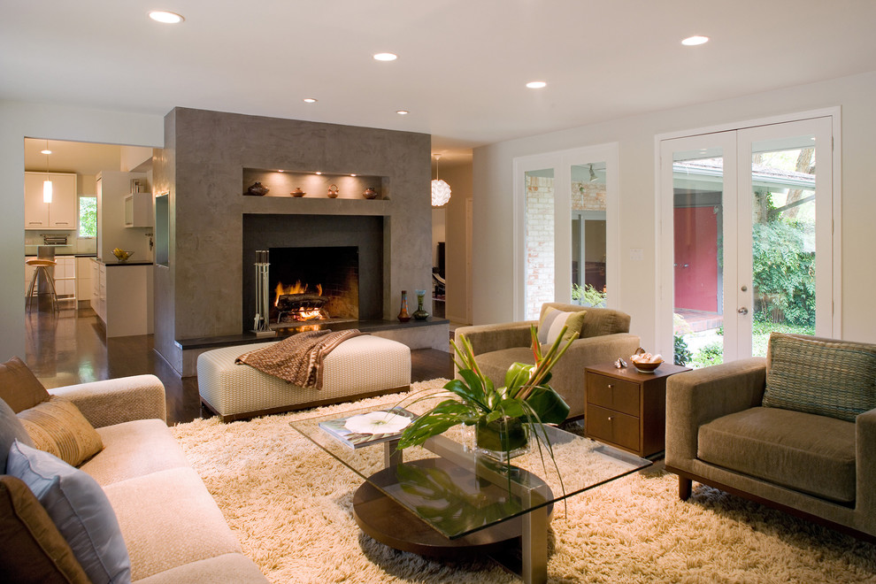 Large contemporary formal living room in New York with a standard fireplace, white walls, dark hardwood flooring and a tiled fireplace surround.