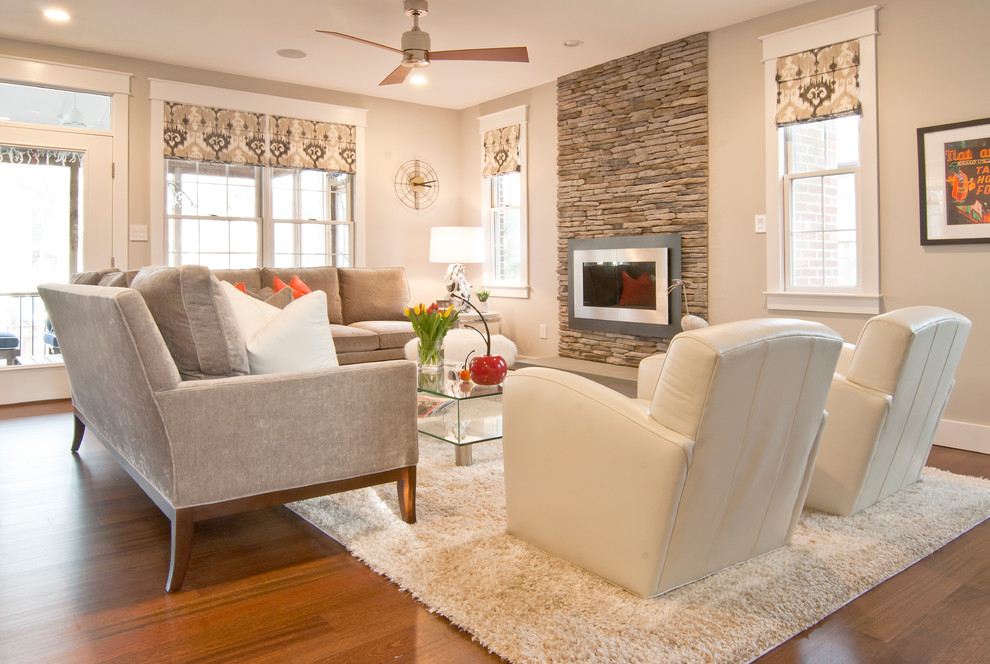 Example of a mid-sized trendy formal and open concept medium tone wood floor living room design in DC Metro with beige walls, no fireplace, a media wall and a stone fireplace