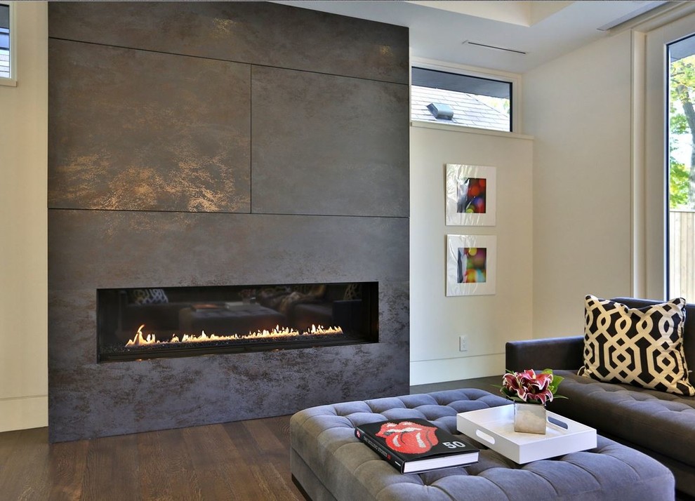 Example of a mid-sized trendy open concept medium tone wood floor living room design in Toronto with white walls, a ribbon fireplace, a tile fireplace and a concealed tv