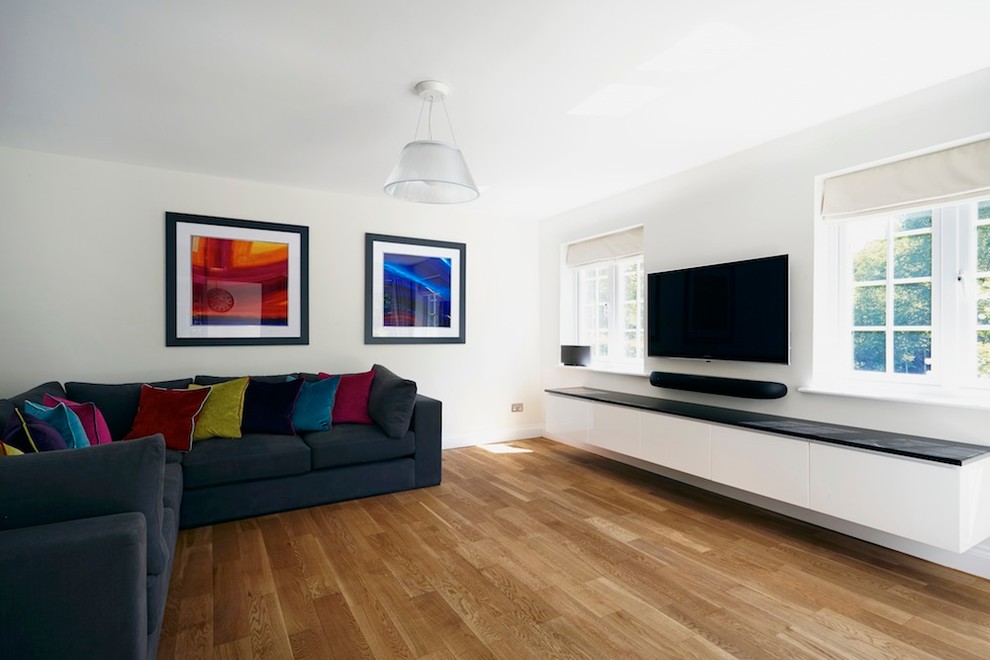 Example of a transitional living room design in Hertfordshire with a concealed tv
