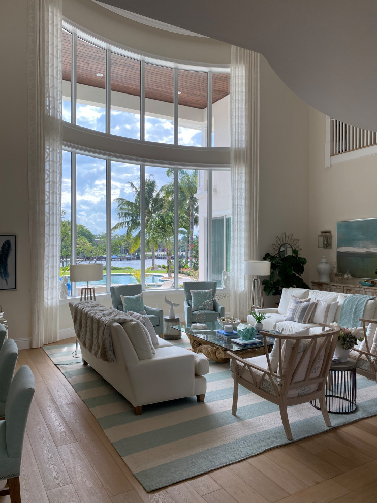 Photo of a beach style living room in Other with beige walls, medium hardwood flooring and brown floors.