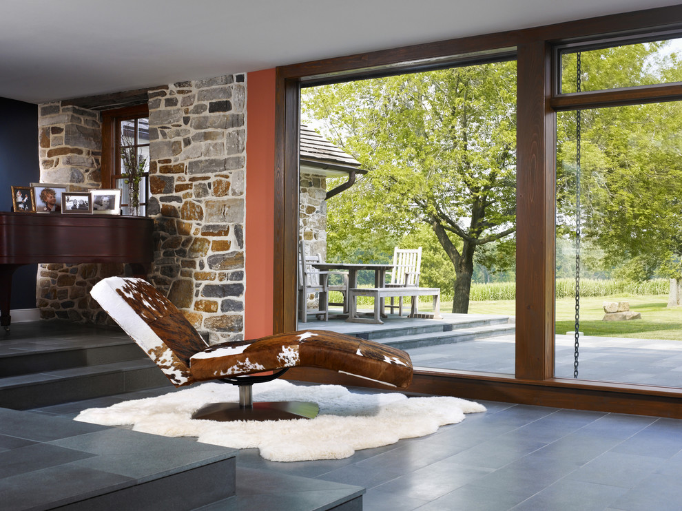 This is an example of a rural open plan living room in Philadelphia with limestone flooring.