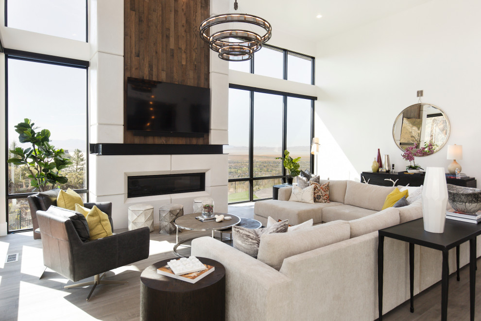 Trendy open concept medium tone wood floor and brown floor living room photo in Salt Lake City with white walls, a ribbon fireplace and a wall-mounted tv