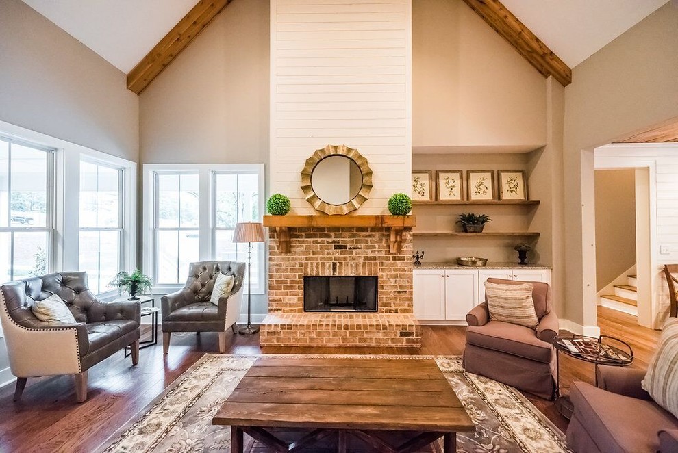 Large farmhouse formal open plan living room in Atlanta with grey walls, medium hardwood flooring, a standard fireplace, a brick fireplace surround, no tv and brown floors.