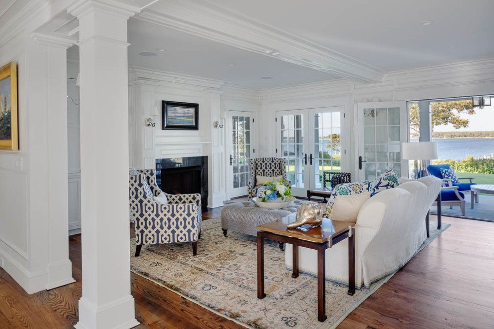 Photo of a medium sized coastal formal enclosed living room in Boston with white walls, medium hardwood flooring, a standard fireplace, a tiled fireplace surround and no tv.