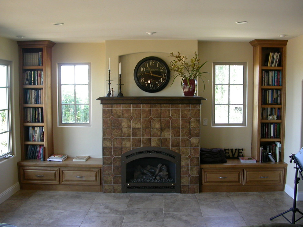 Example of a mid-sized classic open concept porcelain tile living room library design in Santa Barbara with beige walls, a standard fireplace, a tile fireplace and no tv