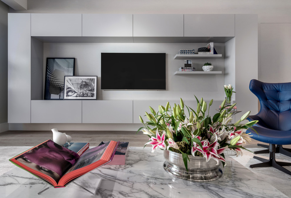 Cette image montre un grand salon minimaliste ouvert avec une salle de réception, un mur gris et un téléviseur encastré.