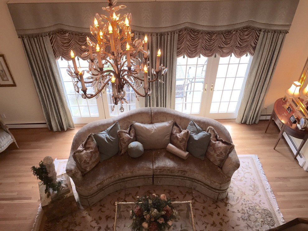 Large traditional formal open plan living room in New York with beige walls, light hardwood flooring, no fireplace and no tv.