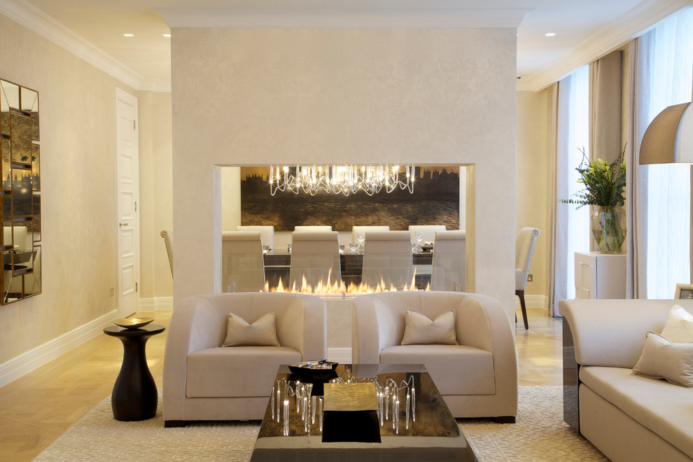 Inspiration for a medium sized contemporary formal enclosed living room in New York with a ribbon fireplace, beige walls, light hardwood flooring, a plastered fireplace surround and no tv.