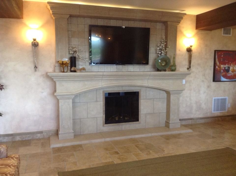 Photo of a large traditional open plan living room in Los Angeles with travertine flooring, a plastered fireplace surround, a wall mounted tv, beige walls and a standard fireplace.