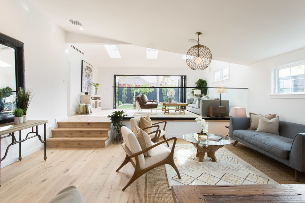 Inspiration for a country open concept light wood floor living room remodel in Los Angeles with white walls and no fireplace