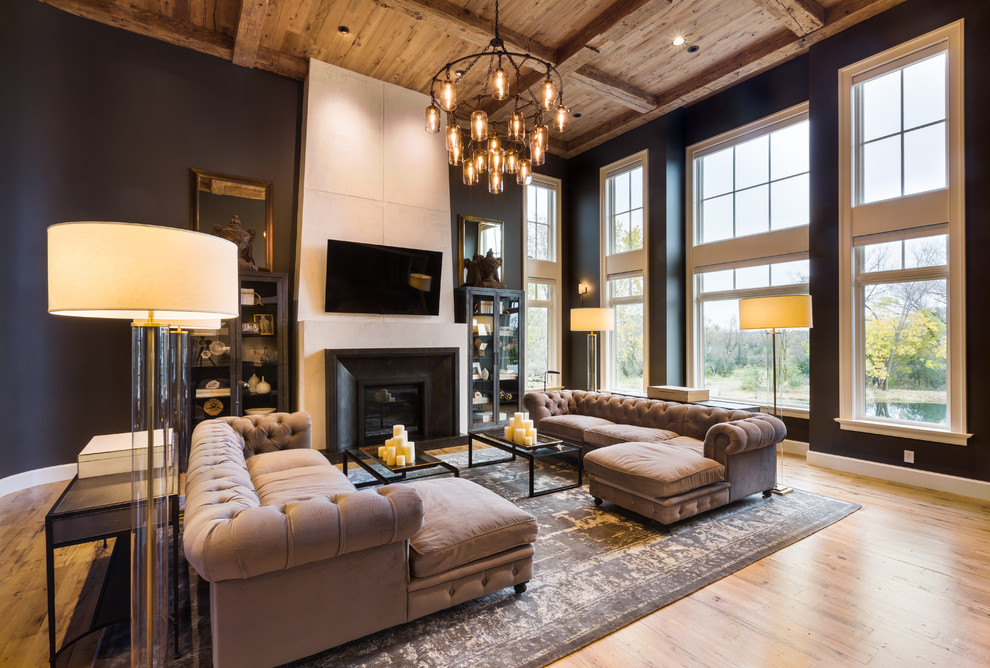 Eclectic formal open plan living room in Milwaukee with black walls, light hardwood flooring, a standard fireplace, a wall mounted tv and yellow floors.
