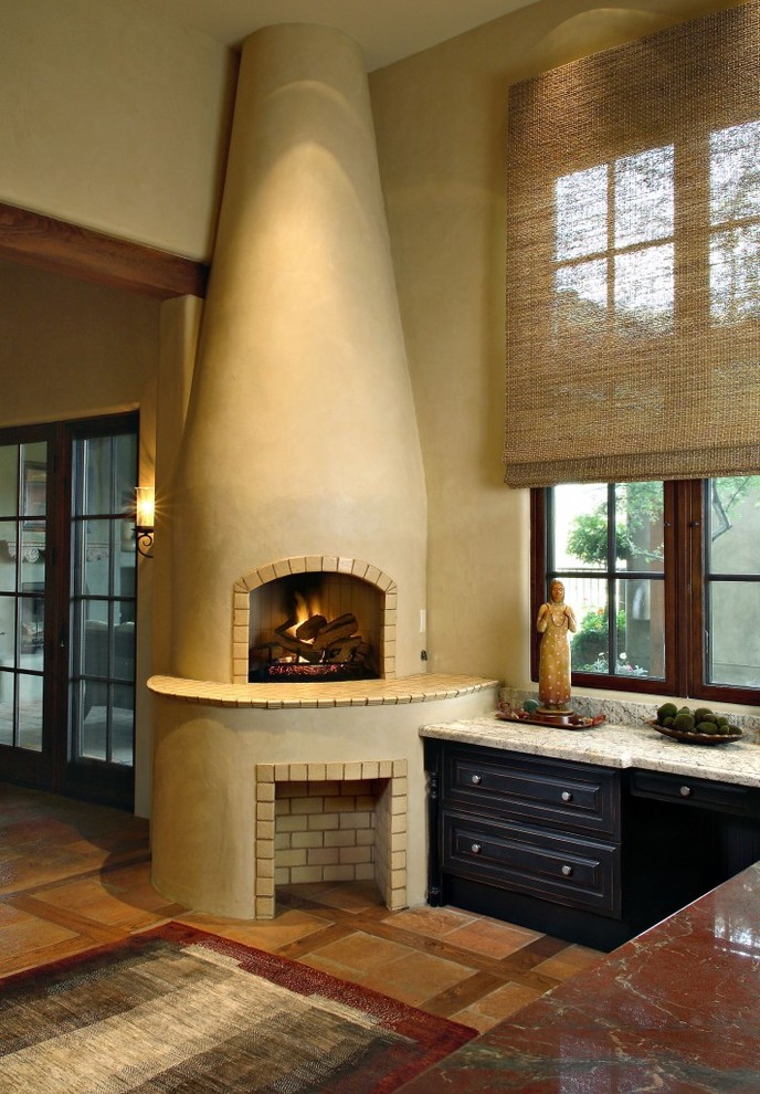 Inspiration for a mediterranean open concept ceramic tile living room remodel in Phoenix with beige walls, a corner fireplace and a plaster fireplace