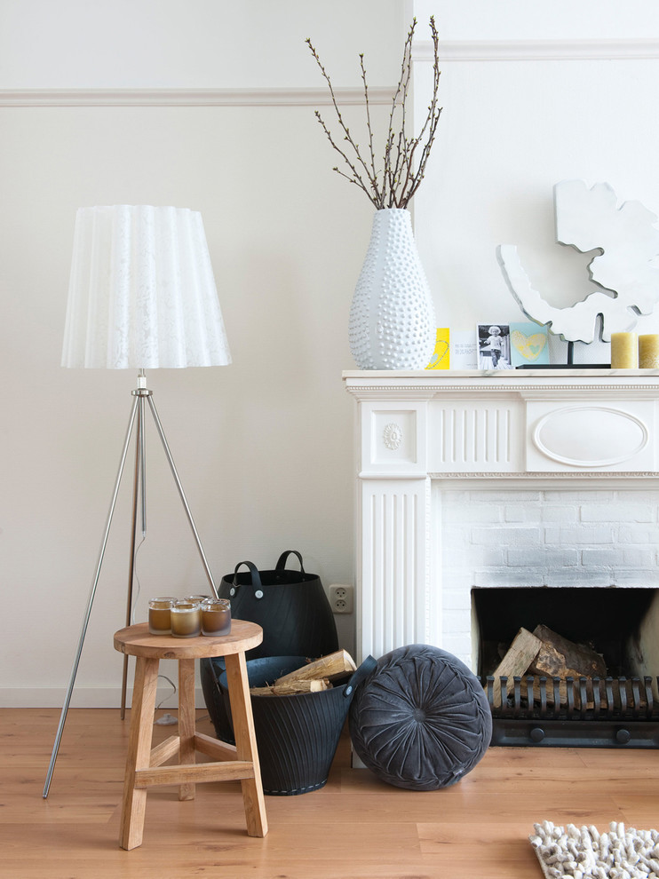 Eclectic living room photo in Amsterdam with a brick fireplace