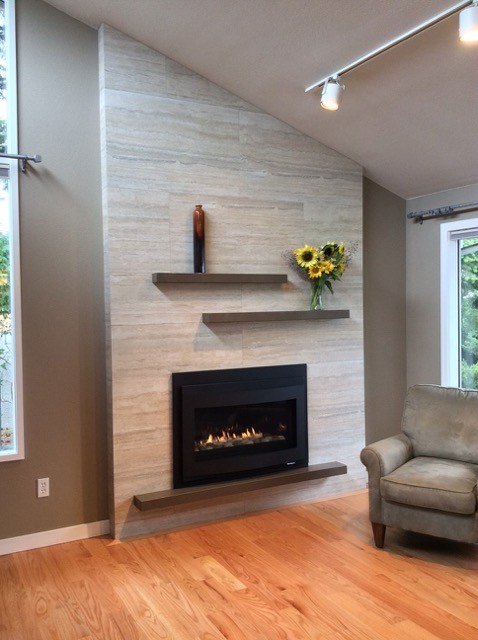 Classic living room in Seattle with brown walls, light hardwood flooring, a standard fireplace and a tiled fireplace surround.
