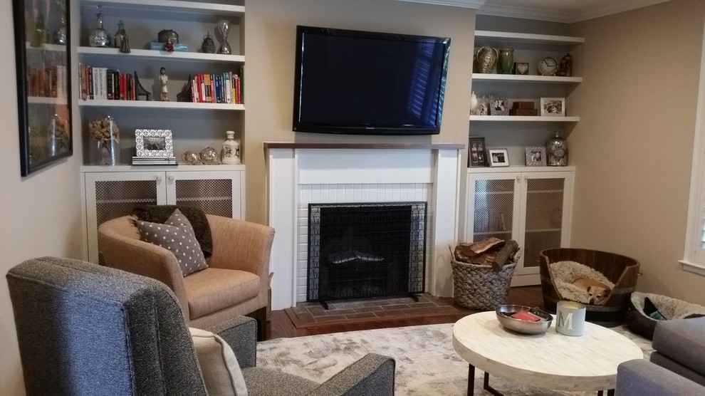 Inspiration for a small traditional enclosed living room in San Francisco with beige walls, medium hardwood flooring, a standard fireplace, a brick fireplace surround and a wall mounted tv.