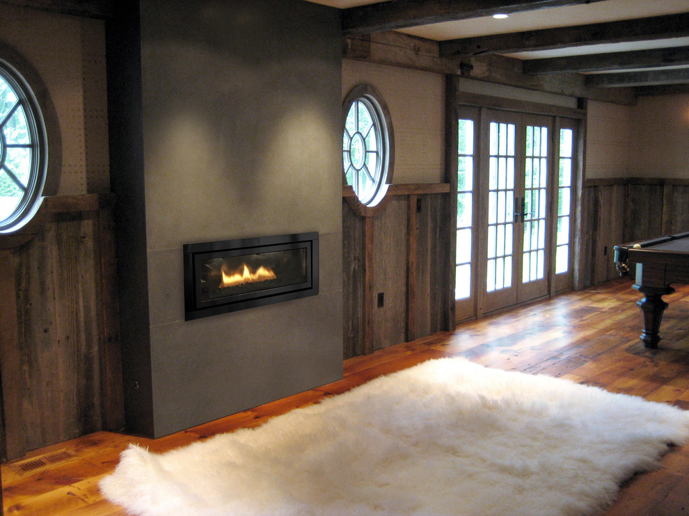 Imagen de salón contemporáneo con marco de chimenea de hormigón
