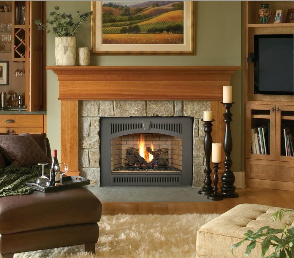 他の地域にある広いトラディショナルスタイルのおしゃれなリビング (緑の壁、淡色無垢フローリング、標準型暖炉、石材の暖炉まわり、茶色い床) の写真