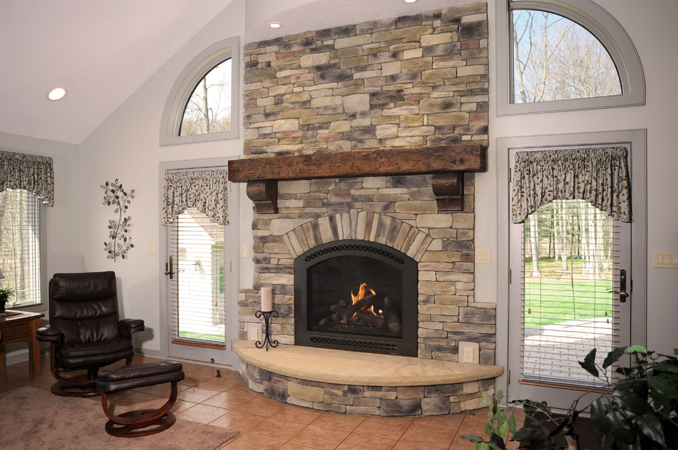 Photo of a medium sized classic formal enclosed living room in Cleveland with beige walls, terracotta flooring, a standard fireplace, a stone fireplace surround, no tv and brown floors.