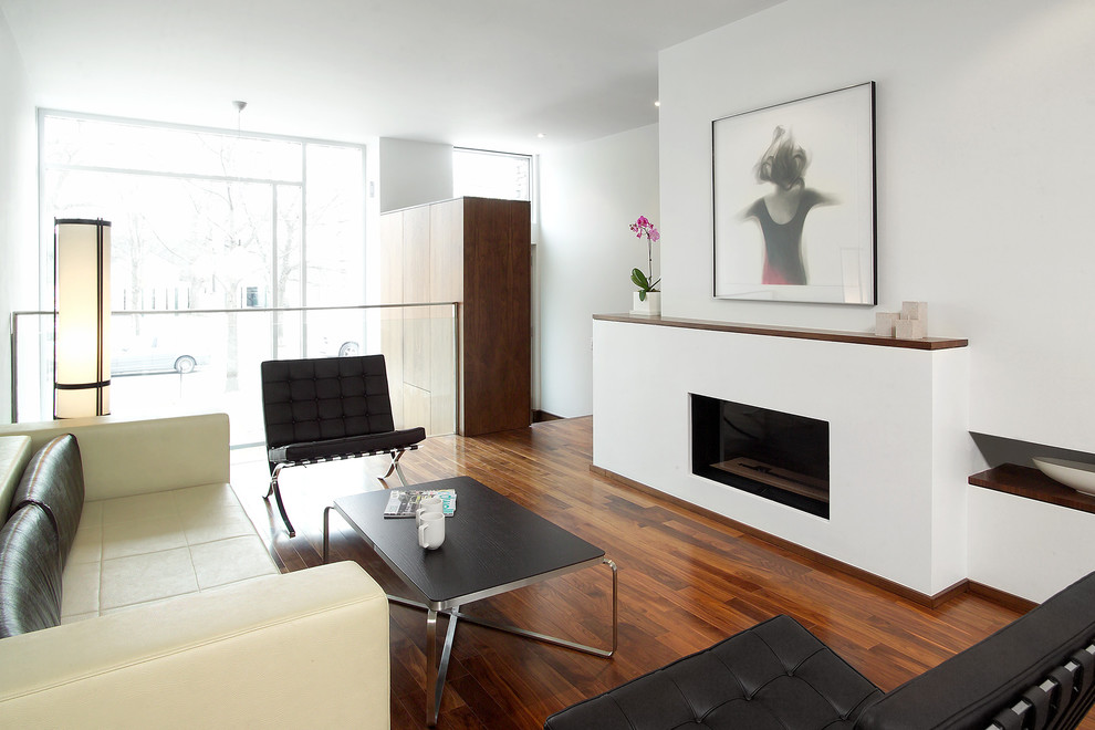 Design ideas for a modern living room in Toronto with white walls and a ribbon fireplace.