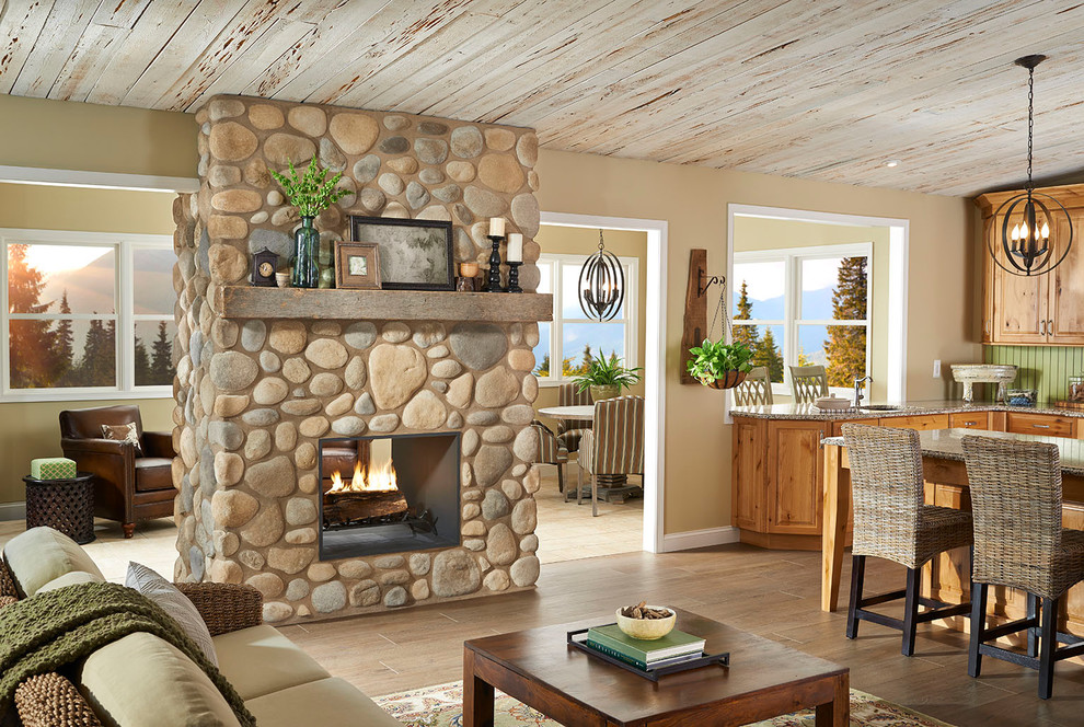 Cette image montre un salon chalet ouvert avec un mur beige, parquet clair, une cheminée double-face et un manteau de cheminée en pierre.