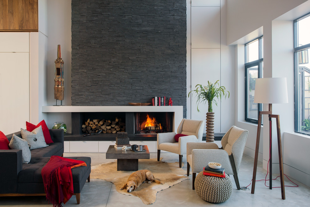 Photo of a contemporary formal open plan living room in Detroit with a ribbon fireplace, white walls and concrete flooring.