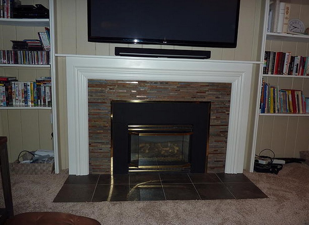 Photo of a medium sized enclosed living room in Seattle with a standard fireplace and a wooden fireplace surround.