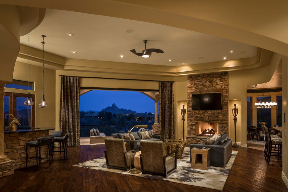 Example of a huge trendy formal and open concept medium tone wood floor living room design in Phoenix with yellow walls, a standard fireplace, a stone fireplace and a wall-mounted tv