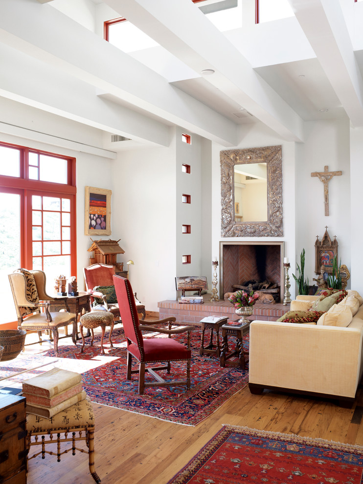 Eclectic formal medium tone wood floor living room photo in Phoenix with white walls and a standard fireplace