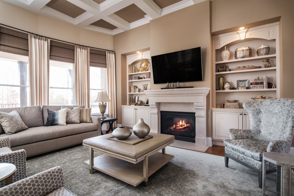 This is an example of a medium sized traditional formal and grey and cream enclosed living room in Charlotte with beige walls, medium hardwood flooring, a standard fireplace, a plastered fireplace surround, a wall mounted tv and brown floors.
