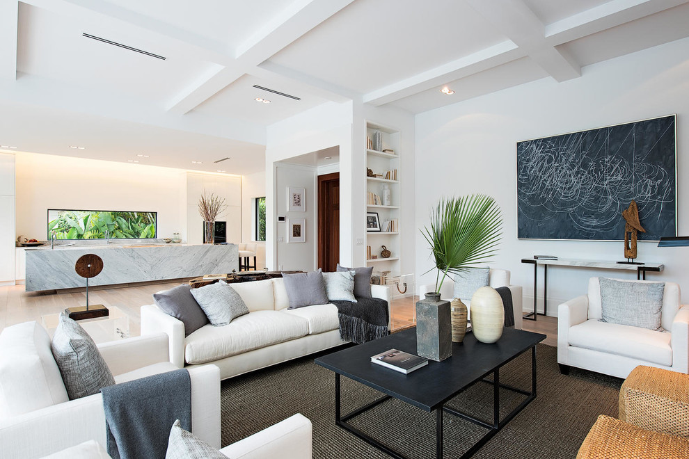 Inspiration for a contemporary open plan living room in Miami with white walls and light hardwood flooring.