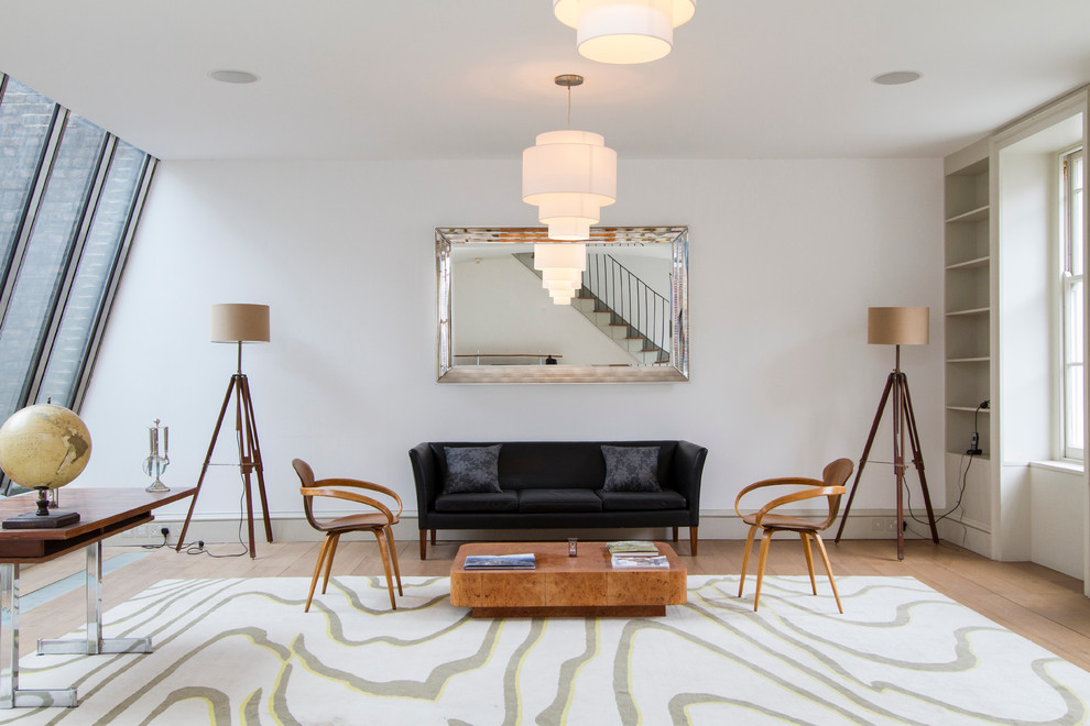 Living room - 1950s medium tone wood floor living room idea in London with white walls