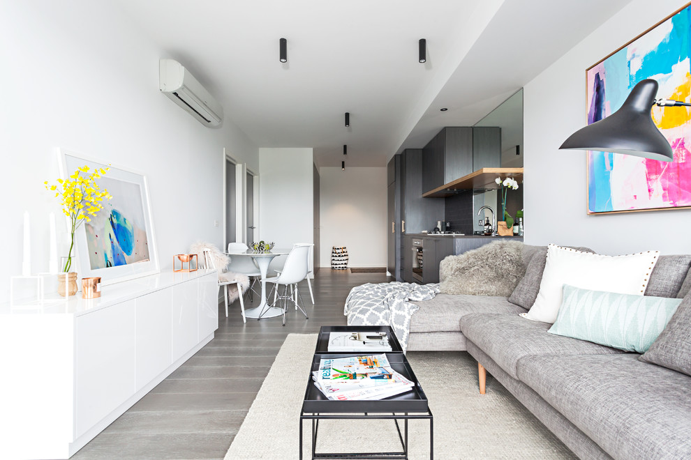 Photo of a small contemporary living room in Melbourne with white walls, medium hardwood flooring, no fireplace and no tv.