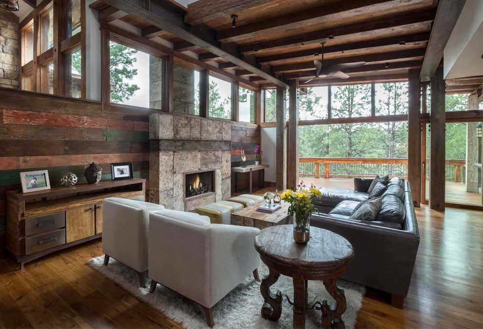 Inspiration for a large rustic open concept dark wood floor and brown floor living room remodel in Phoenix with a metal fireplace and a standard fireplace