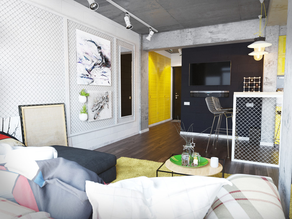 Ispirazione per un piccolo soggiorno industriale stile loft con pareti nere, pavimento in legno verniciato, cornice del camino in cemento e TV a parete
