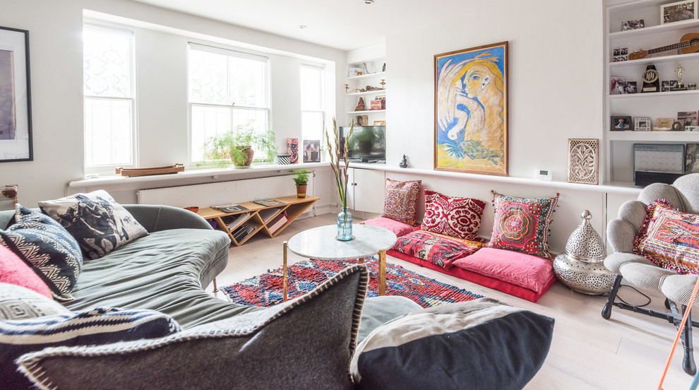 Inspiration for a mid-sized eclectic enclosed living room remodel in London with white walls