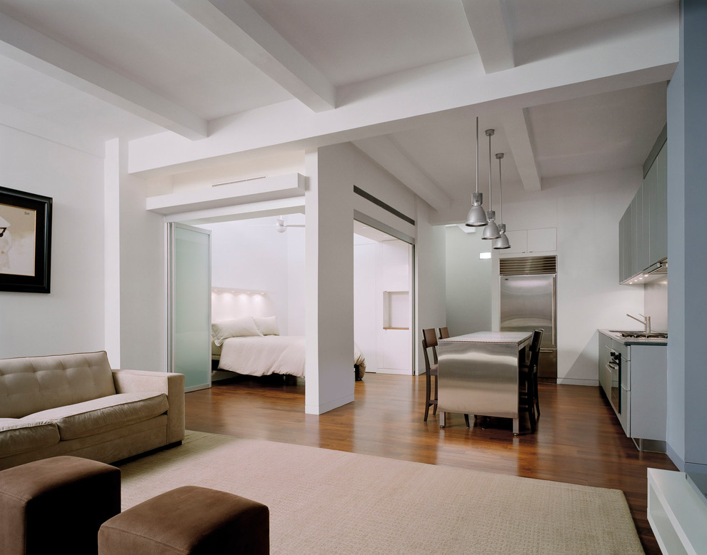 Esempio di un piccolo soggiorno minimalista stile loft con pareti grigie, parquet scuro e pavimento marrone