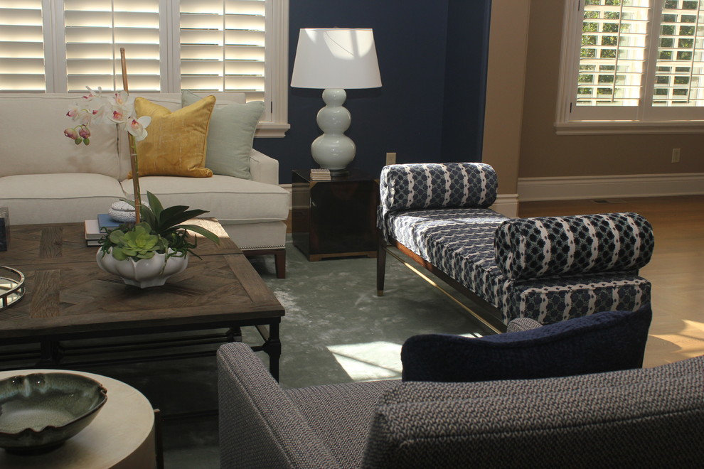 На фото: большая парадная, изолированная гостиная комната в стиле неоклассика (современная классика) с синими стенами, паркетным полом среднего тона, стандартным камином, фасадом камина из камня и бежевым полом без телевизора