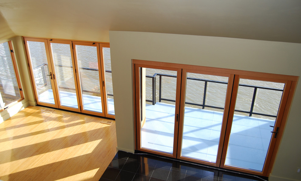 This is an example of a medium sized contemporary mezzanine living room in Portland with bamboo flooring.