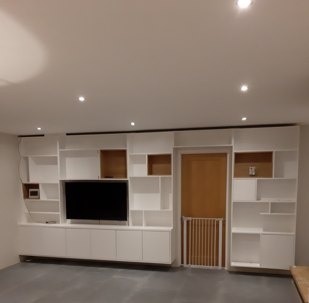 This is an example of a large modern open plan living room in Dublin with a wall mounted tv.