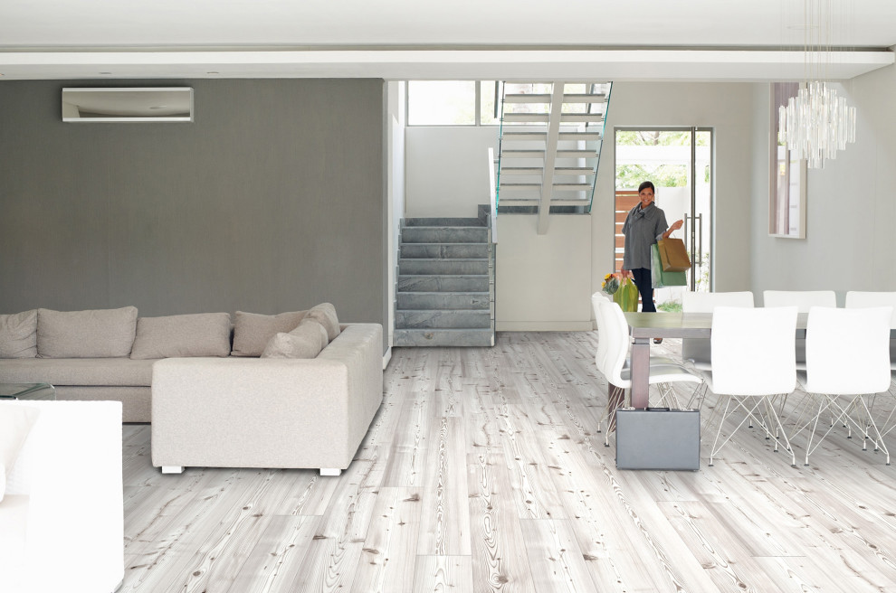 Ispirazione per un soggiorno minimalista con pareti grigie, pavimento in sughero, pavimento bianco e pannellatura